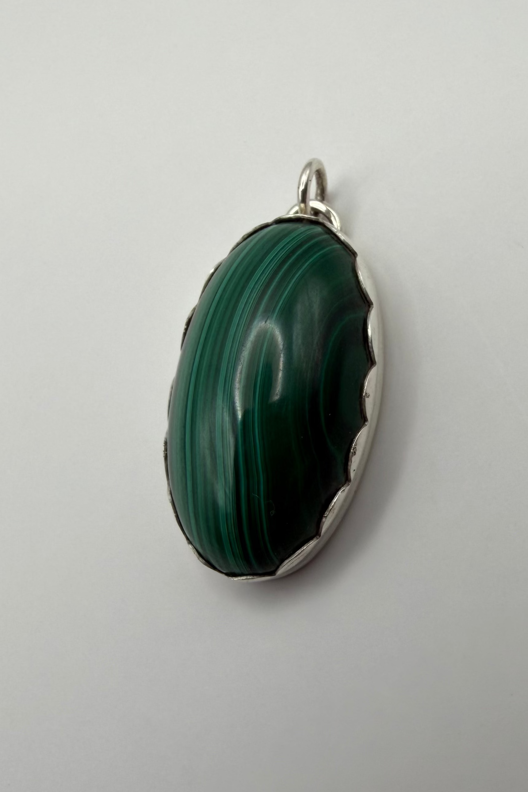 side view of pendant featuring a scalloped bezel.