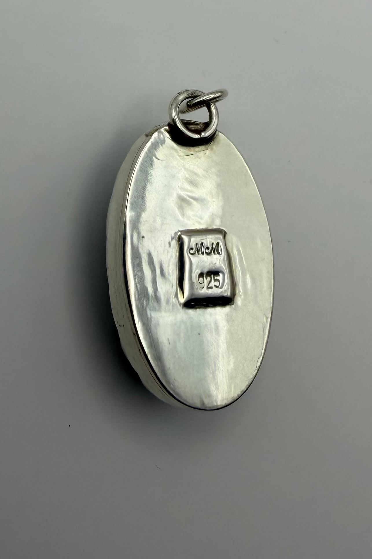 backside of pendant, showing a "925" stamp.