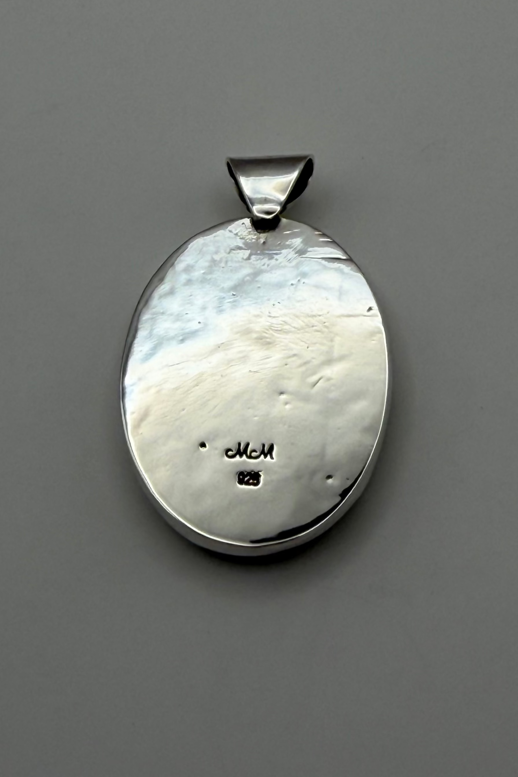 backside of pendant showing "925" stamp.