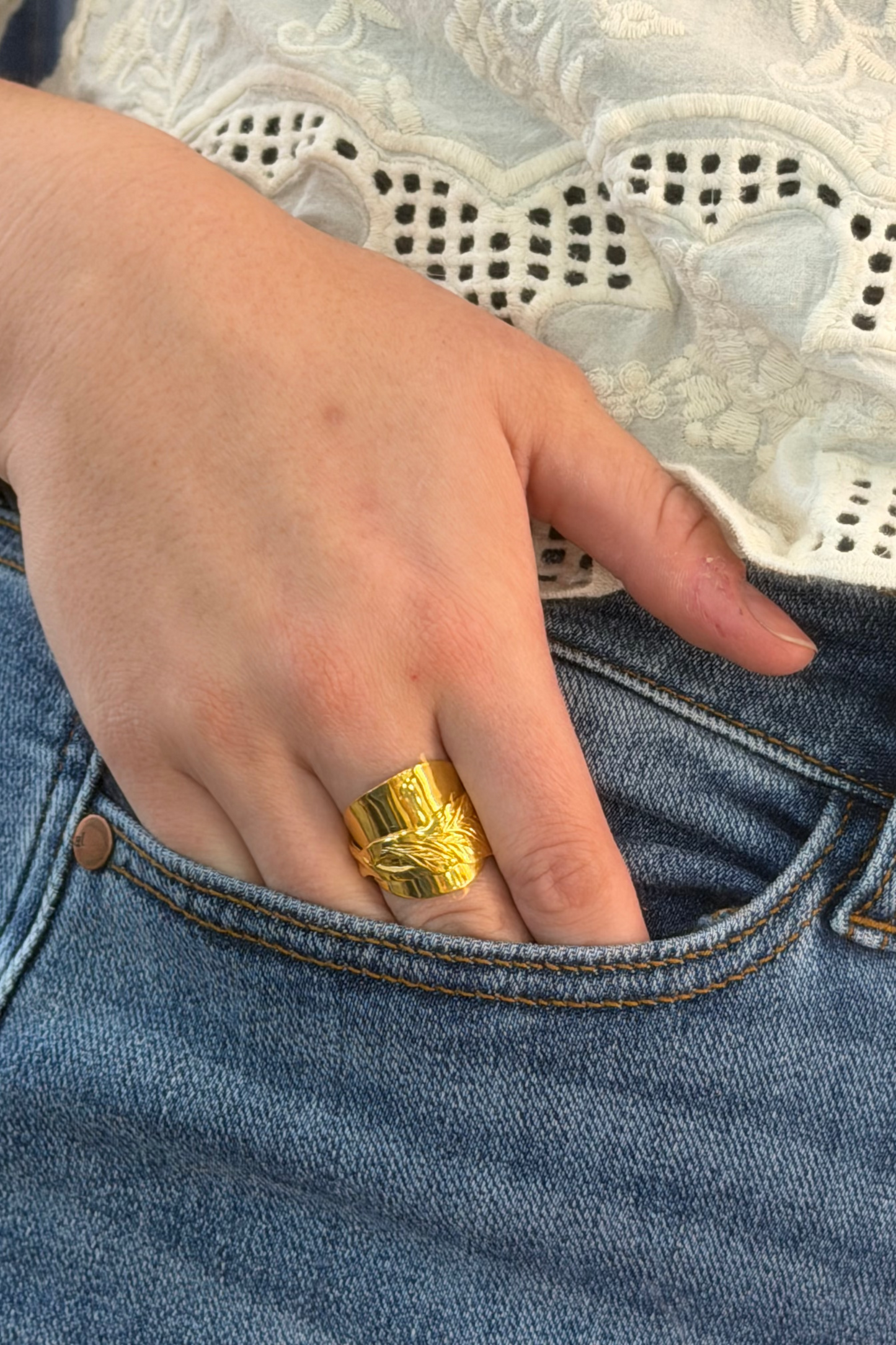 Ring shown on hand, tucked in pocket.