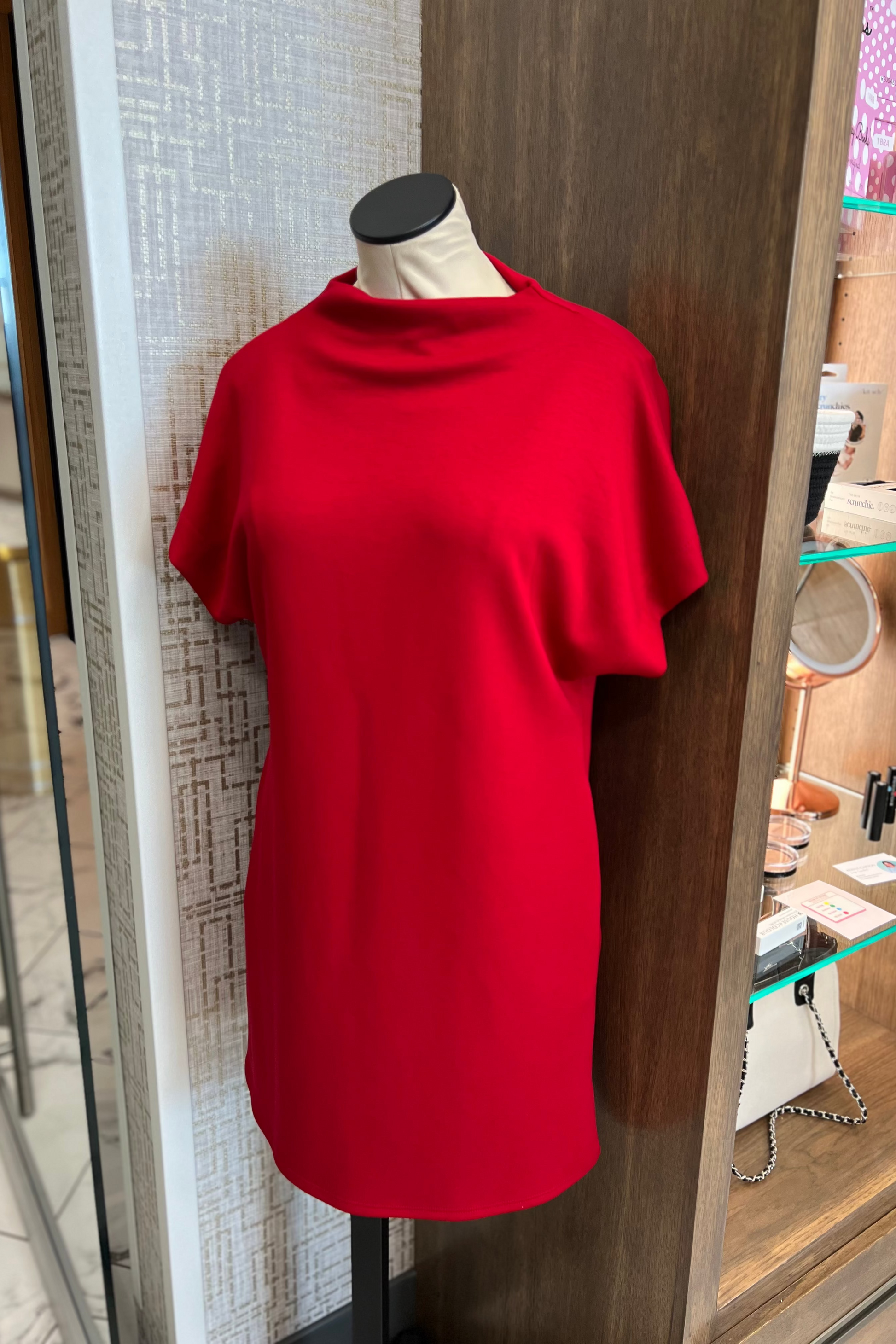 Red dress on a mannequin in a store setting