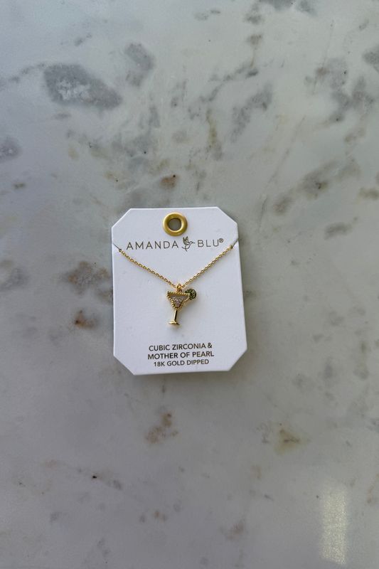 Gold necklace with a martini against a marble background