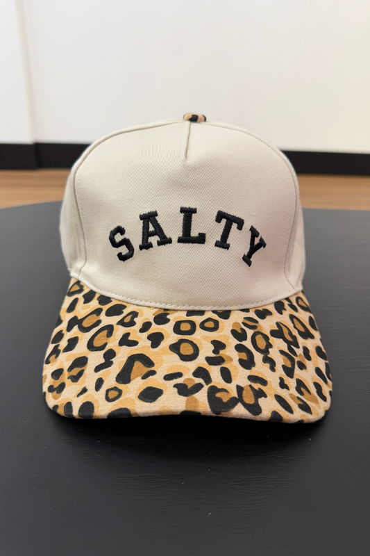 Cap with 'SALTY' text and leopard print brim on a black surface