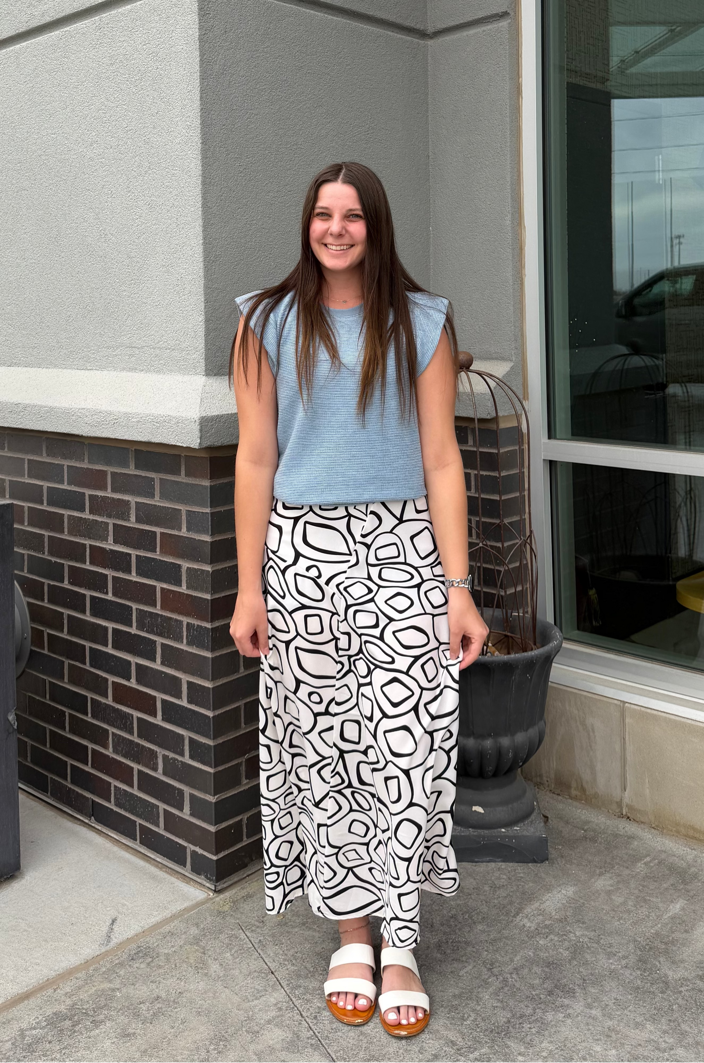 Woman standing outside a building with a large window