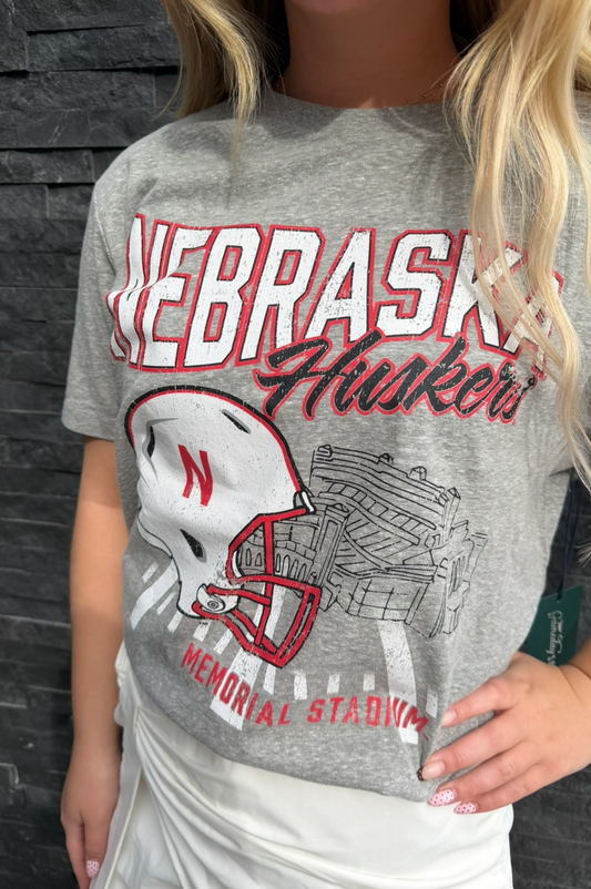 Gray t-shirt with 'Nebraska' and football helmet design on a dark background