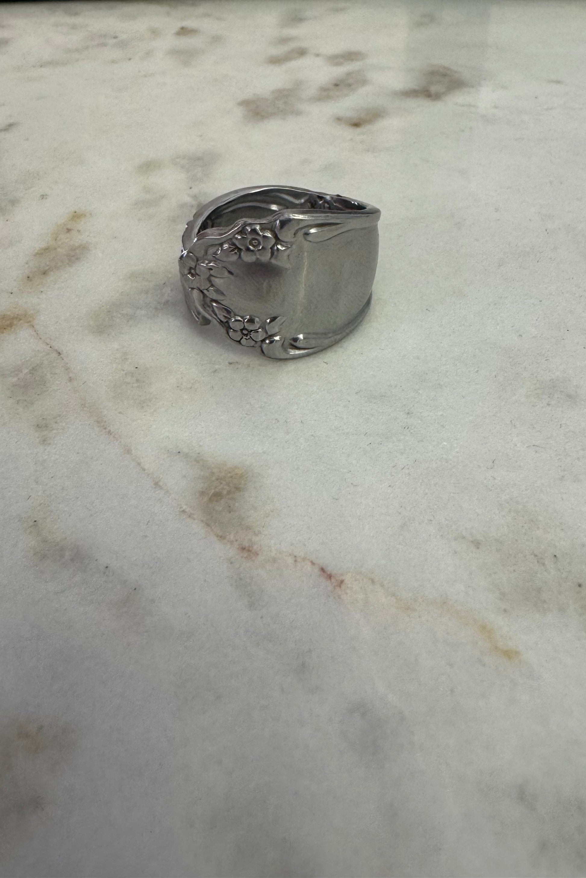 Silver ring on a marble surface