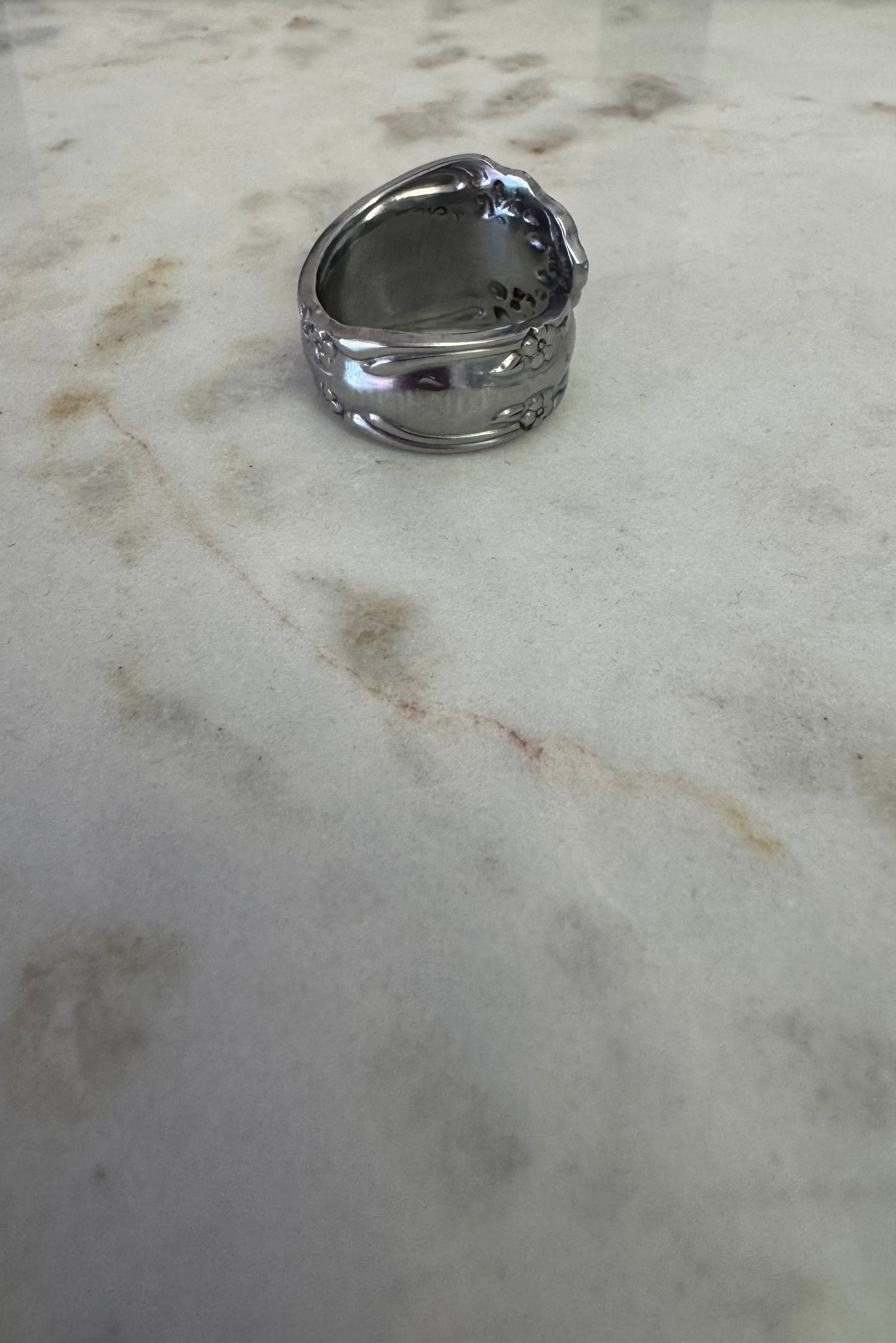 Silver ring on a marble surface