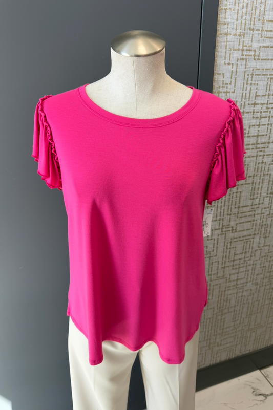 Pink top on a mannequin against a gray wall