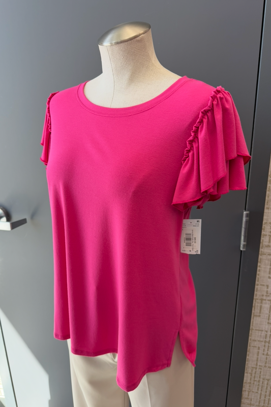 Pink blouse on a mannequin against a gray wall