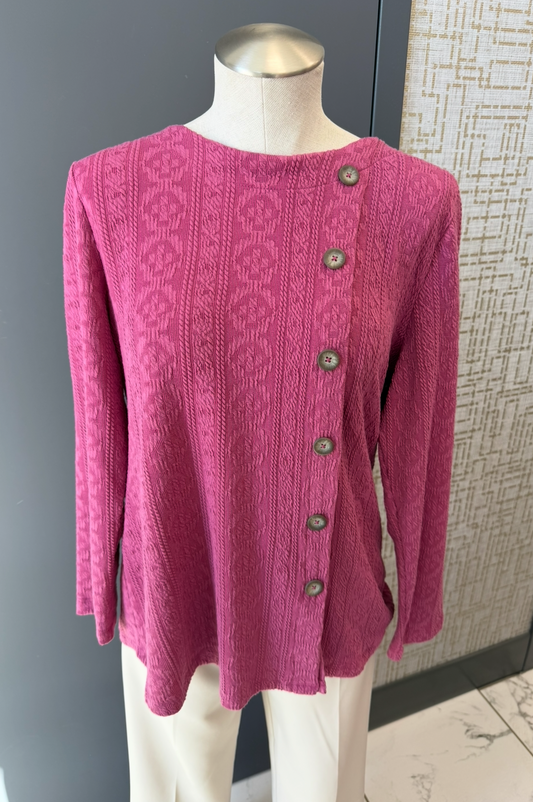 Pink sweater on a mannequin against a neutral background