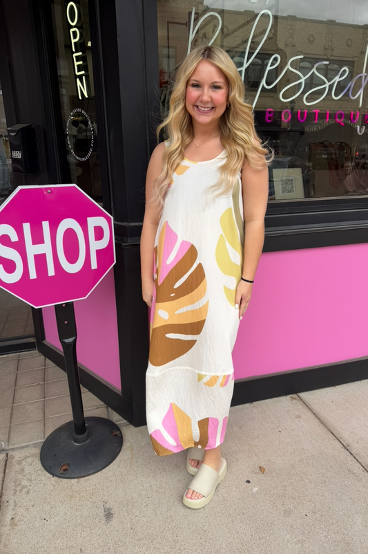 Woman standing in front of a store with a 'Shop' sign and 'Blessed' sign.