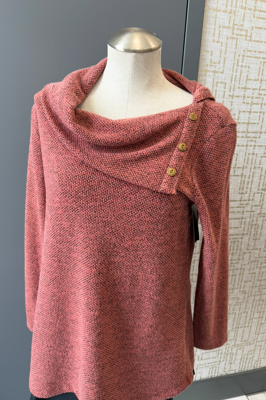 Red sweater on a mannequin against a neutral background