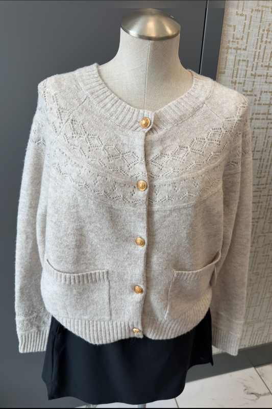 Light gray cardigan on a mannequin against a neutral background