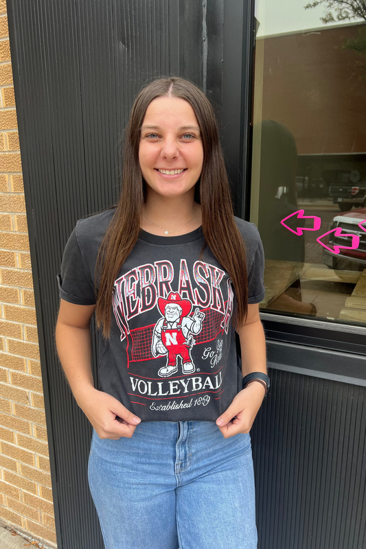 Person wearing a Nebraska Volleyball t-shirt.