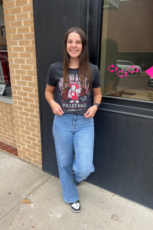 Person wearing a Nebraska Volleyball t-shirt.