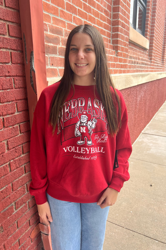 Person wearing a red 'Nebraska Volleyball' sweatshirt.
