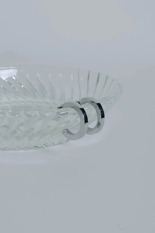Clear glass bowl with decorative rim on a white background