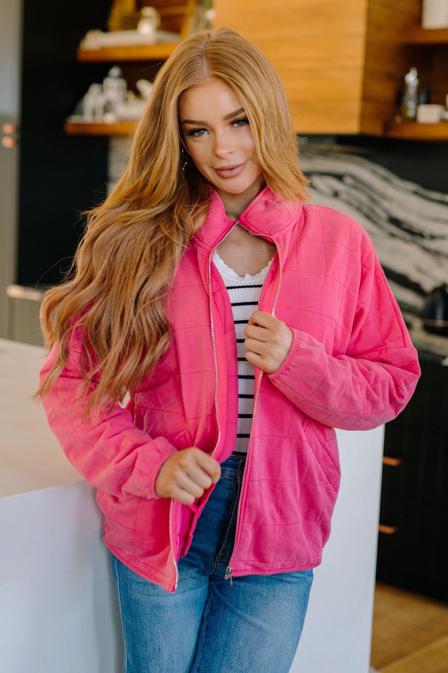 Woman wearing a pink jacket in an indoor setting