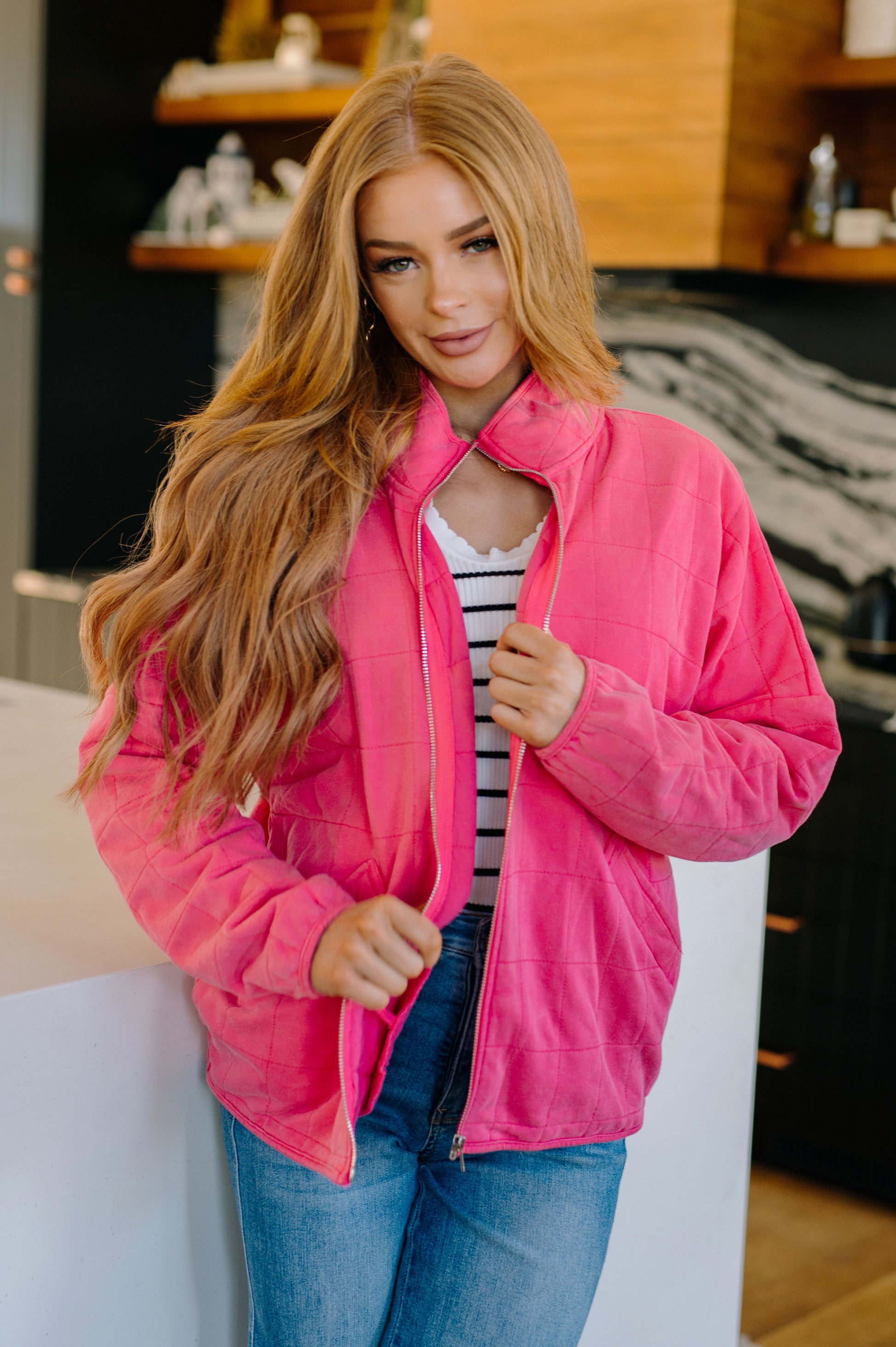 Woman wearing a pink jacket in an indoor setting