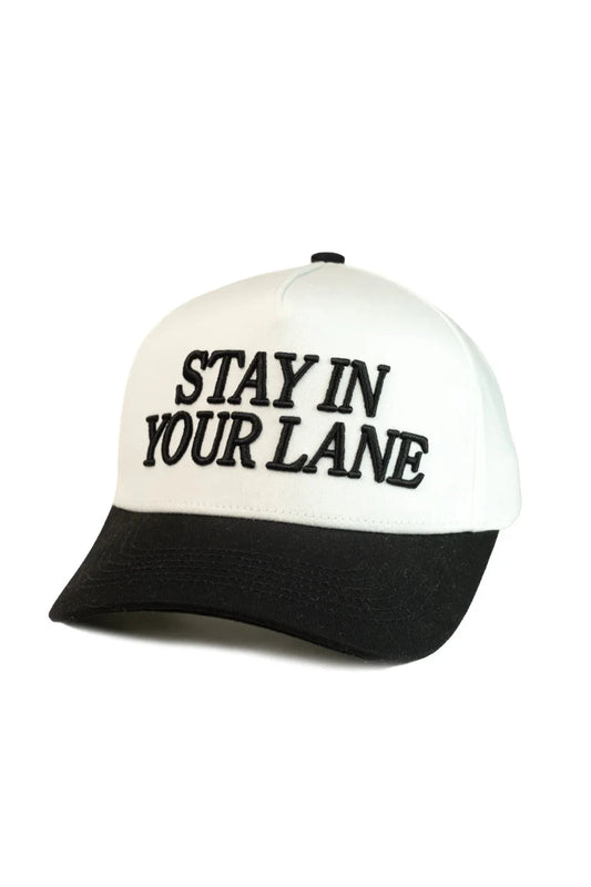 White and black cap with 'Stay in Your Lane' text on a white background