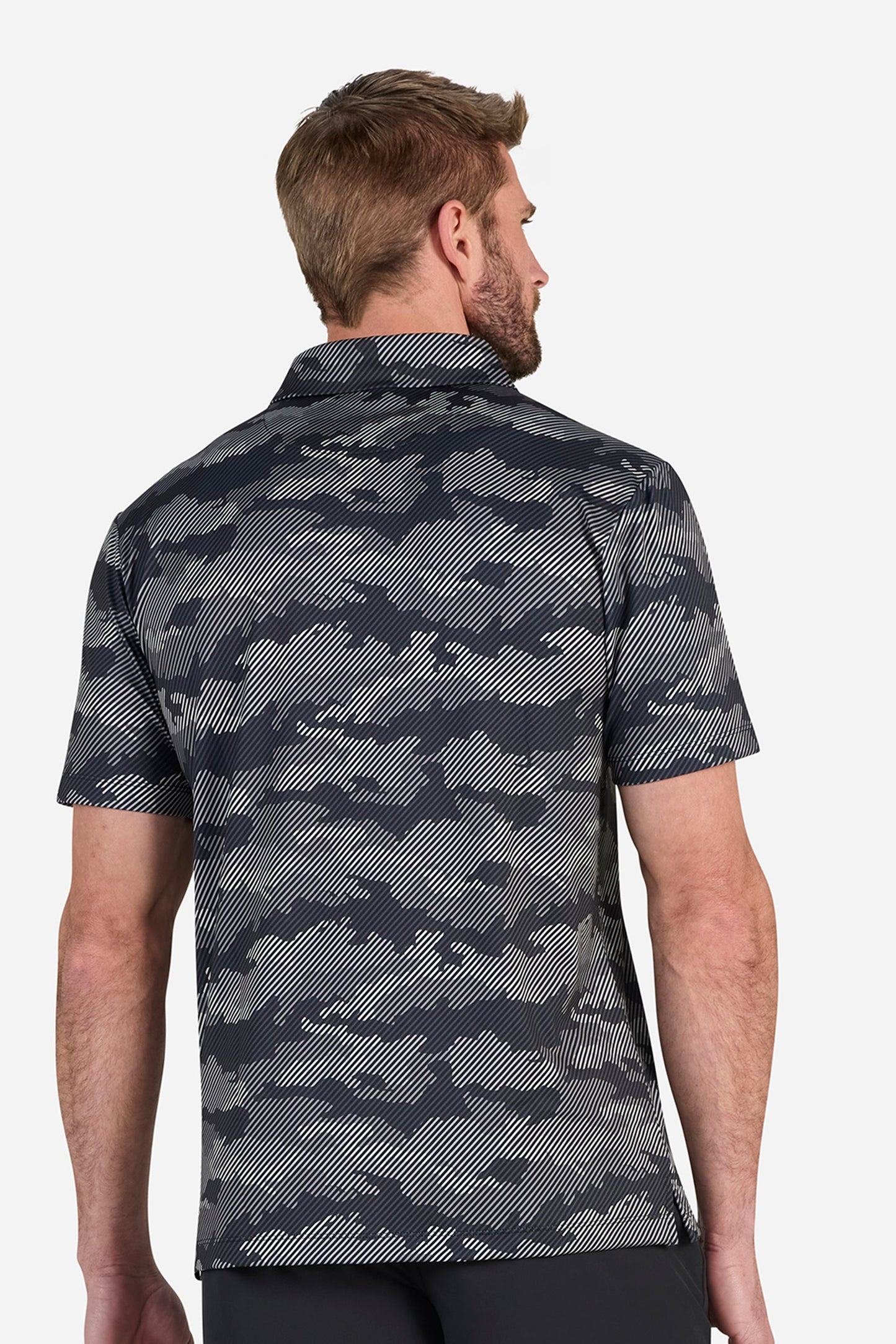 Man wearing a camouflage patterned shirt on a white background