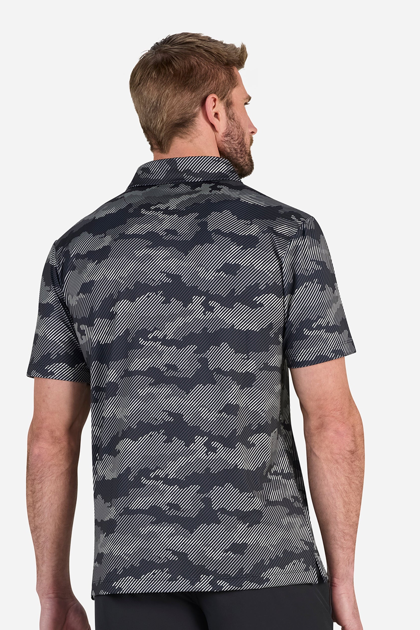 Man wearing a camouflage patterned shirt on a white background
