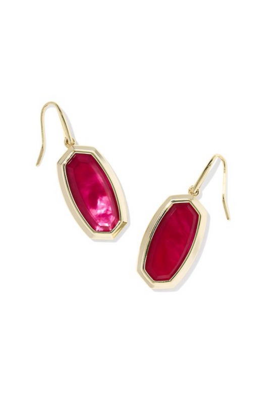 Gold earrings with red-pink gemstones on a white background