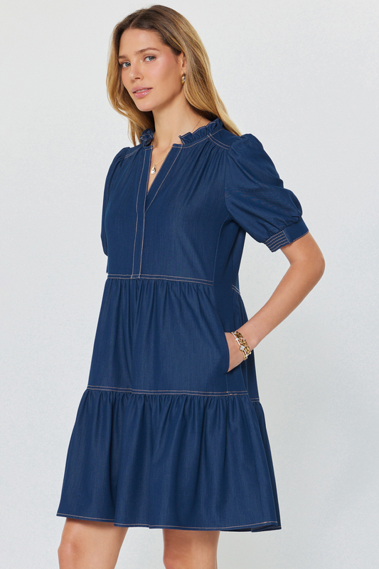 Woman wearing a blue dress against a white background