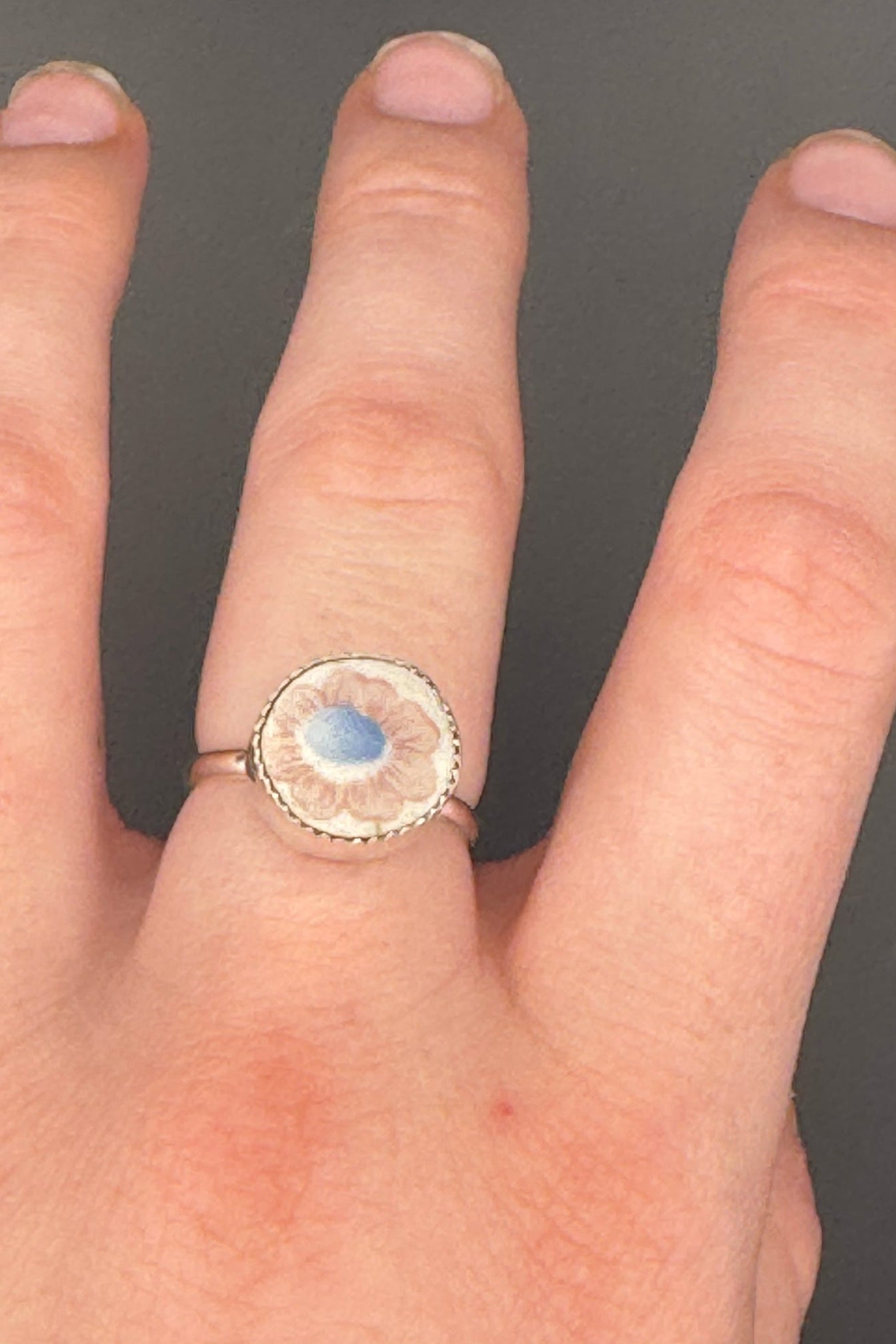 Floral design ring displayed on hand