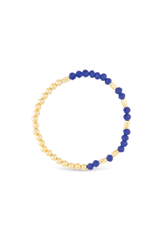 Bracelet with blue beads and gold chain on a white background