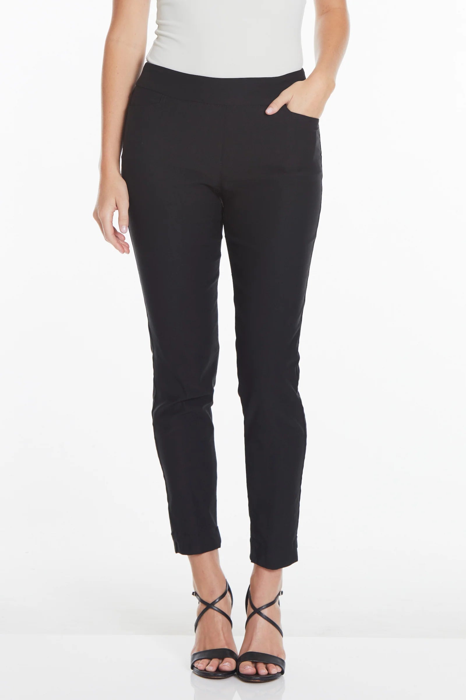 Person wearing black pants and a white top on a white background