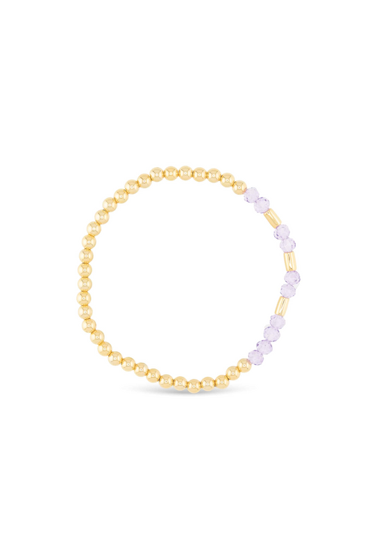 Gold and purple beaded bracelet on a white background