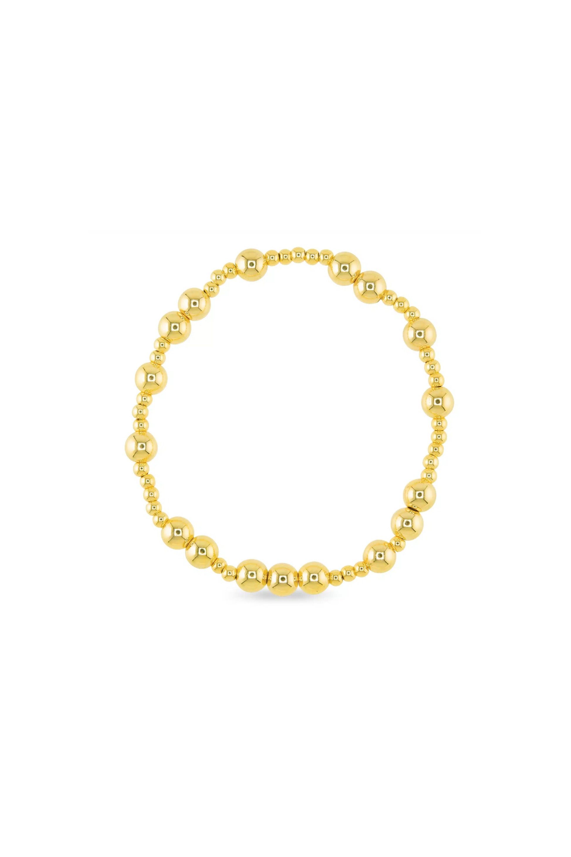 Gold beaded bracelet on a white background