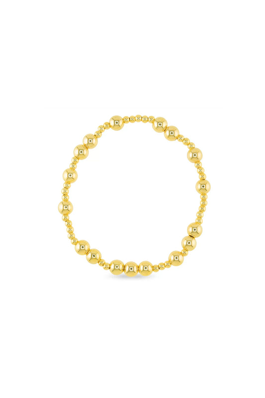Gold beaded bracelet on a white background