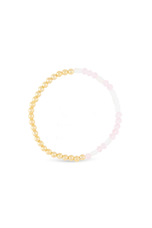 Gold beaded bracelet on a white background