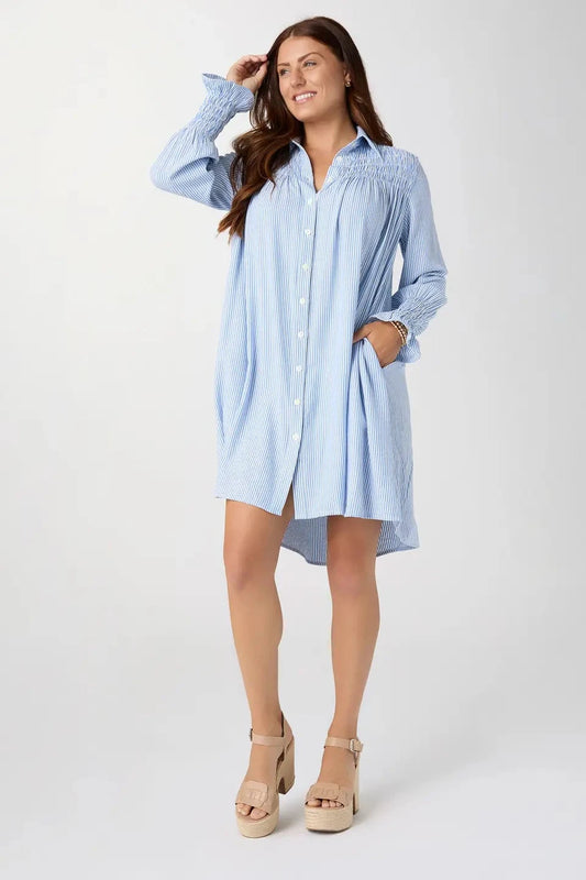 Woman wearing a light blue dress on a white background