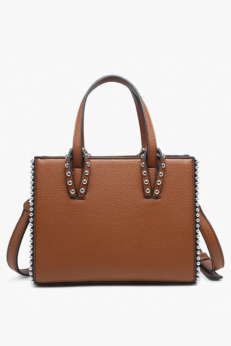 Brown handbag with studded details on a white background