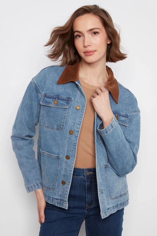 Woman wearing a blue denim jacket with brown collar on a white background