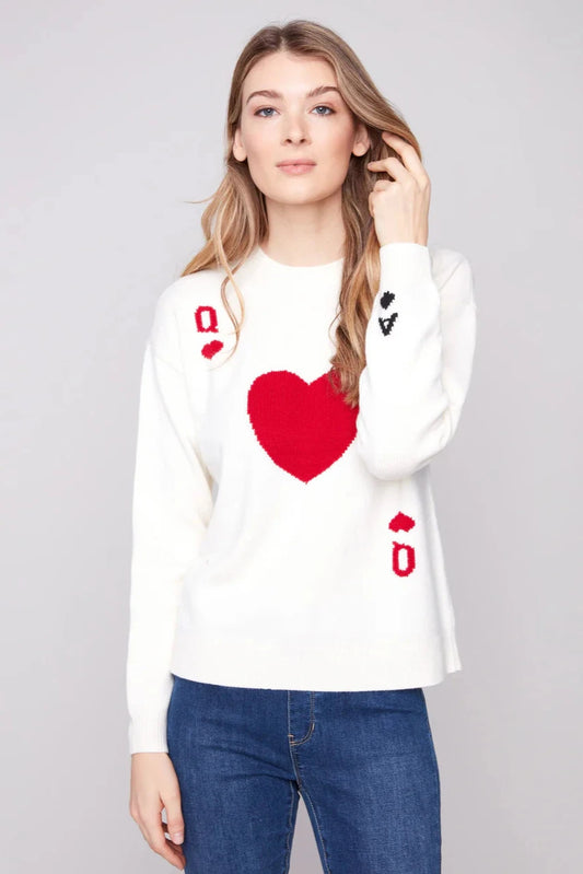 Woman wearing a white sweater with red heart design on a gray background