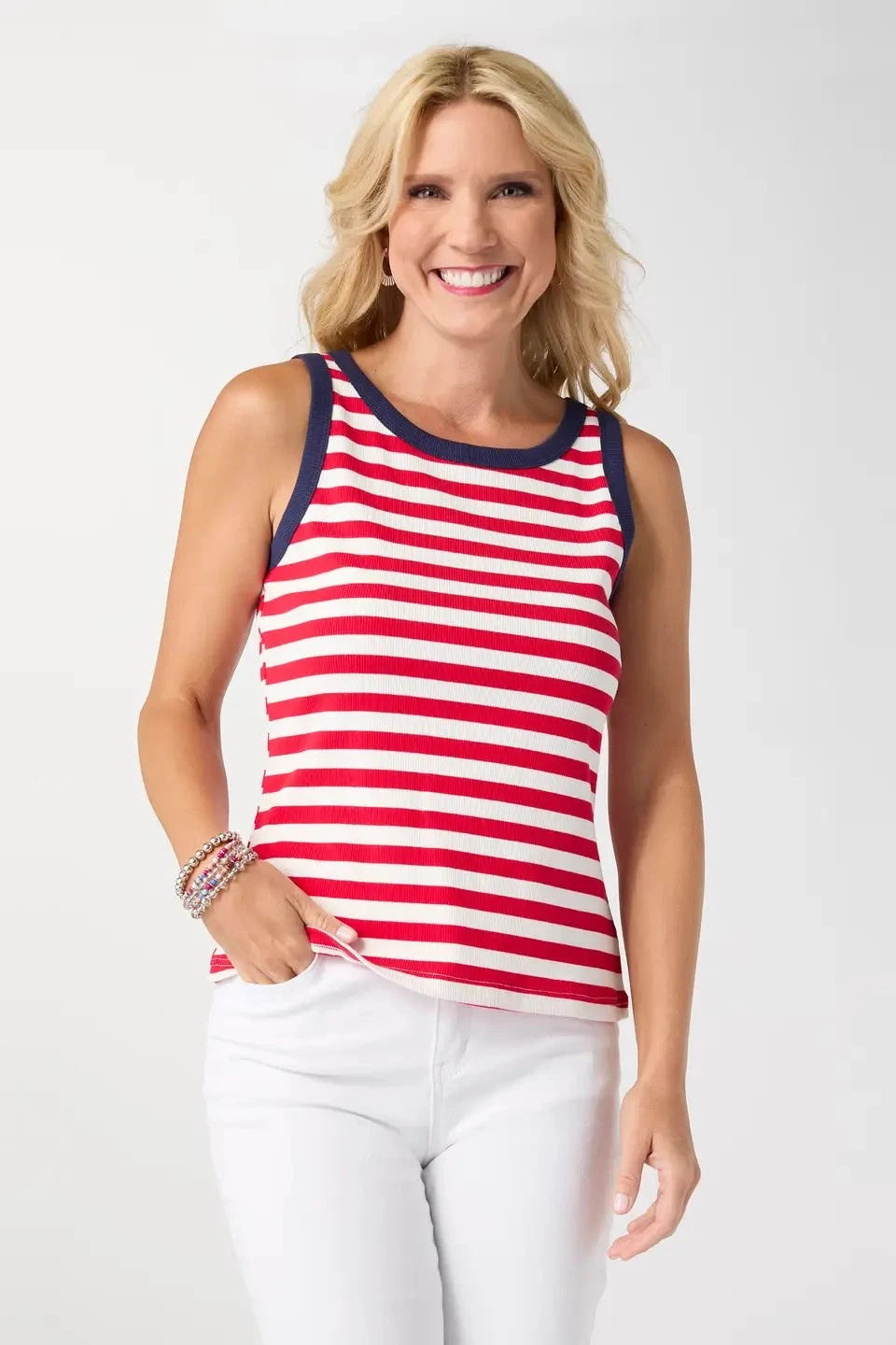 Woman wearing a red and white striped tank top with a plain background