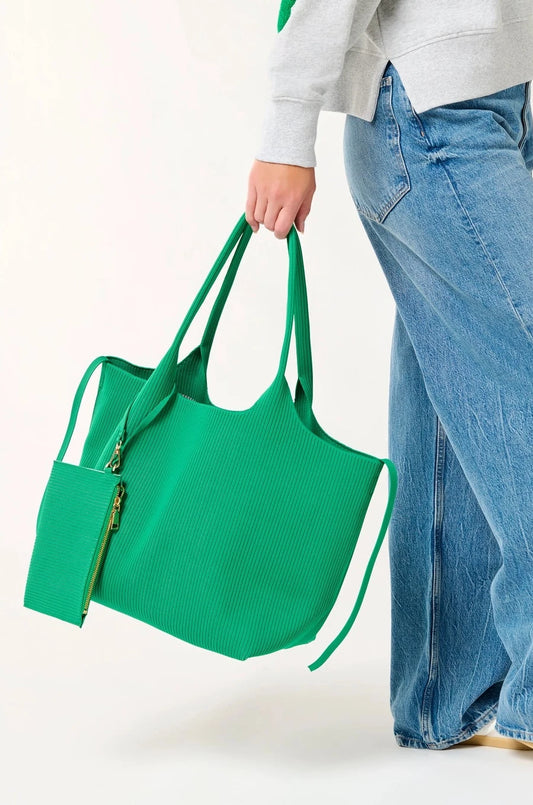 woman holding green tote