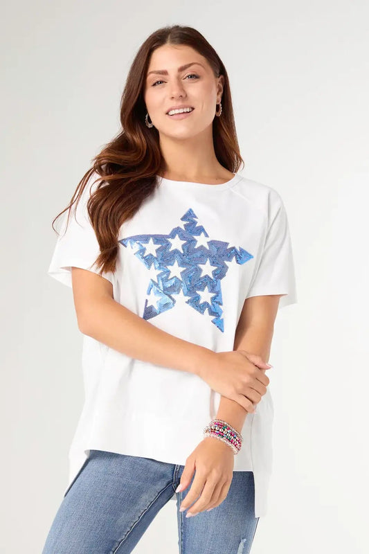 Woman wearing a white t-shirt with blue star design on a plain background