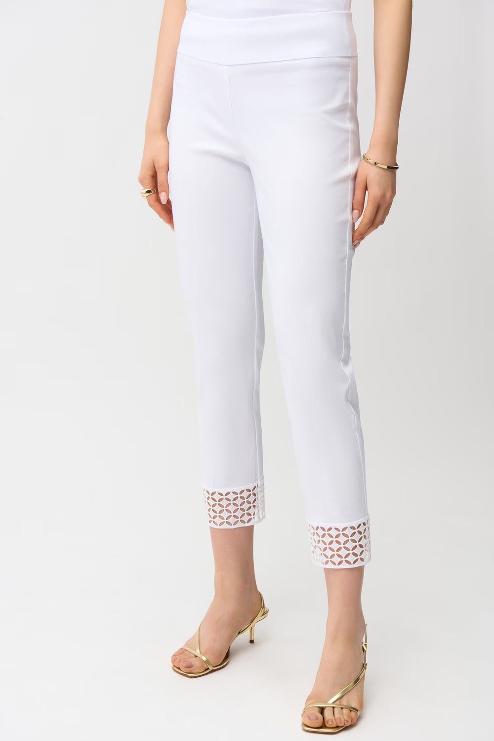 White pants with lace detailing on a white background