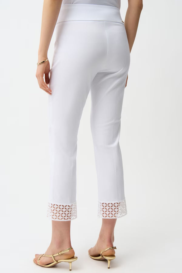White pants with decorative cuffs on a white background