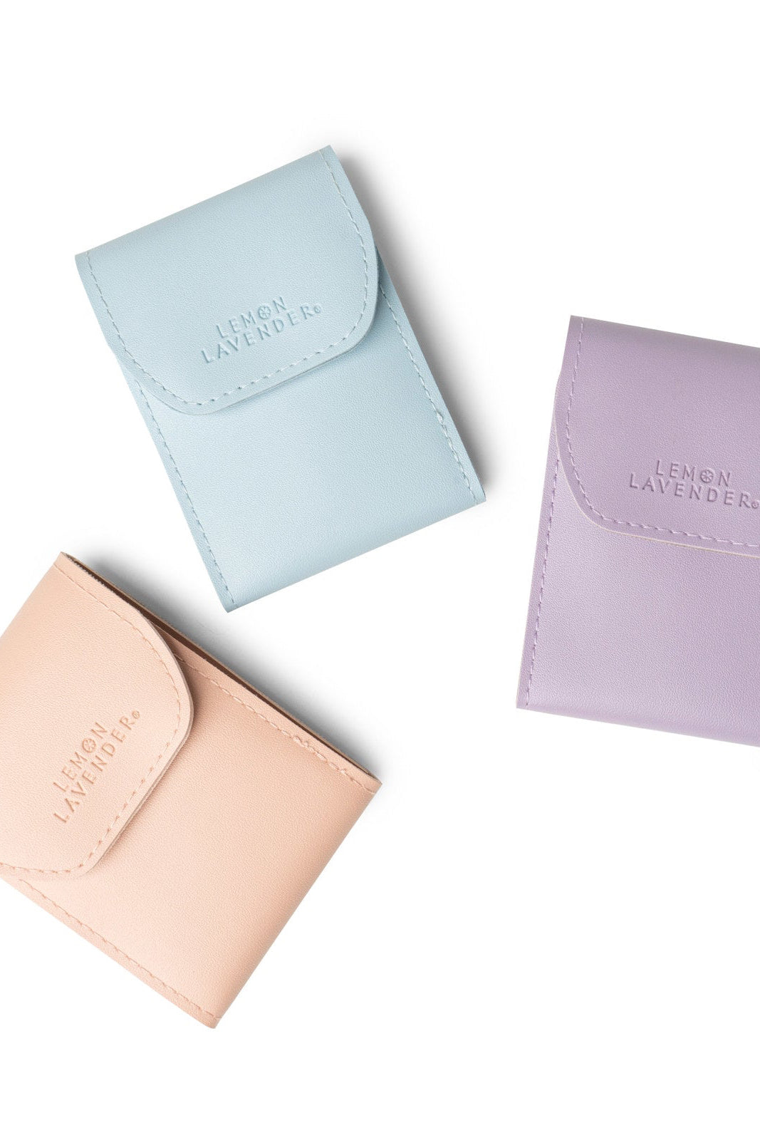 Three pastel-colored pouches with 'Lemon Lavender' branding on a white background