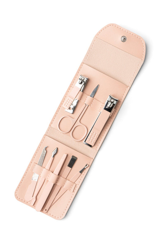 Manicure set with tools in a beige leather case on a white background