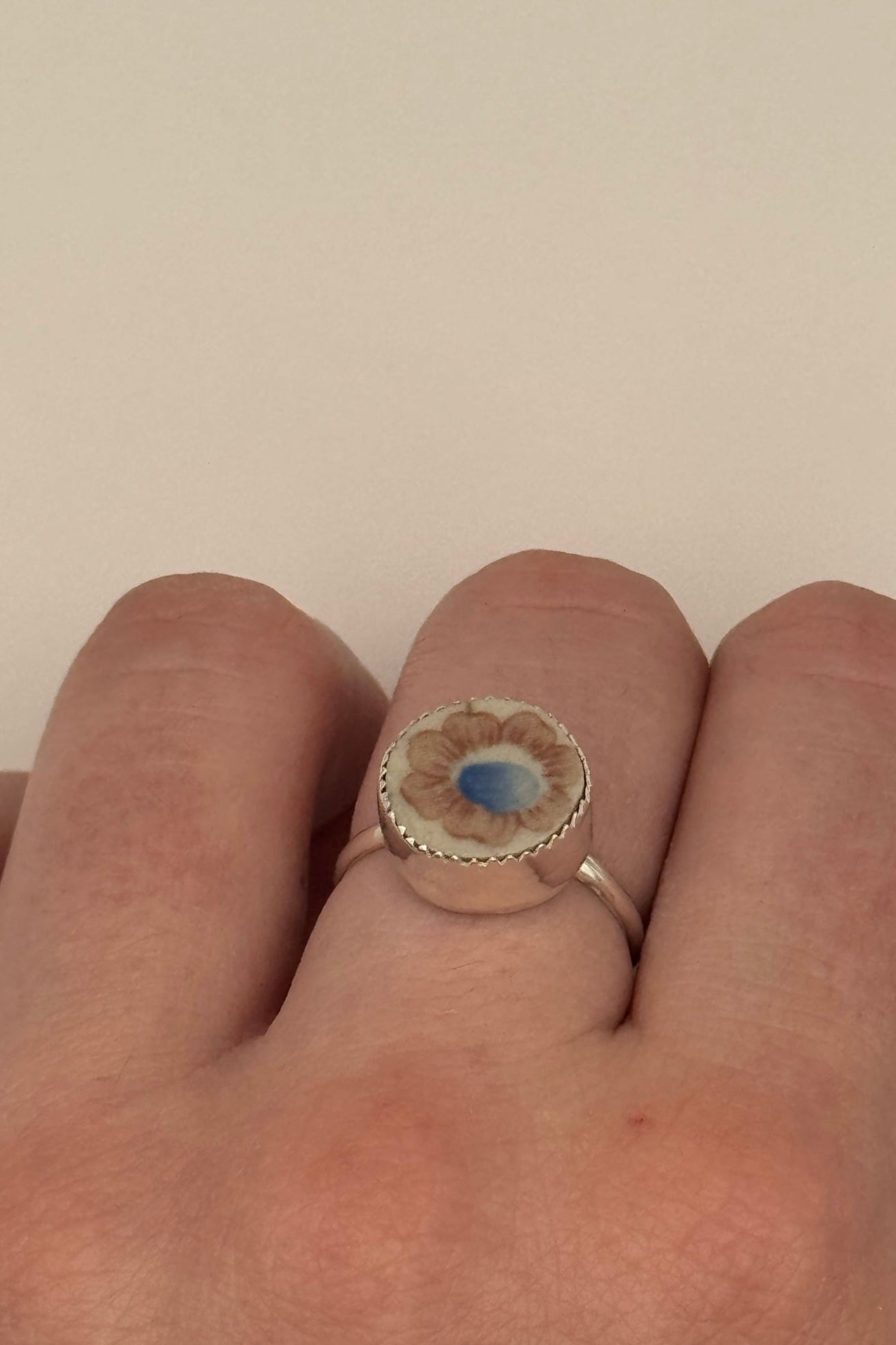 Floral design ring displayed on hand