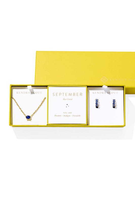 Jewelry set with necklace and earrings in a yellow box on a white background