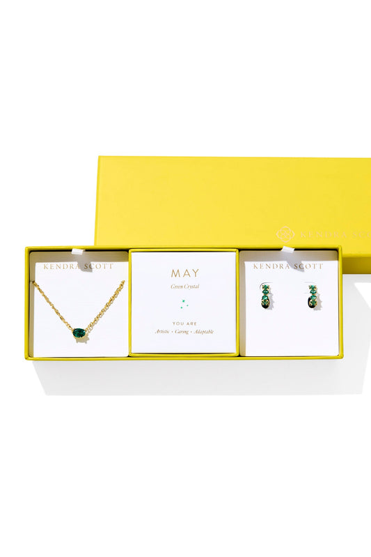 Jewelry set with necklace and earrings in a yellow box on a white background