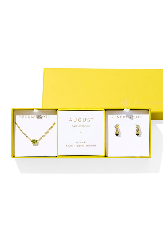 Jewelry set with necklace and earrings in a yellow box on a white background